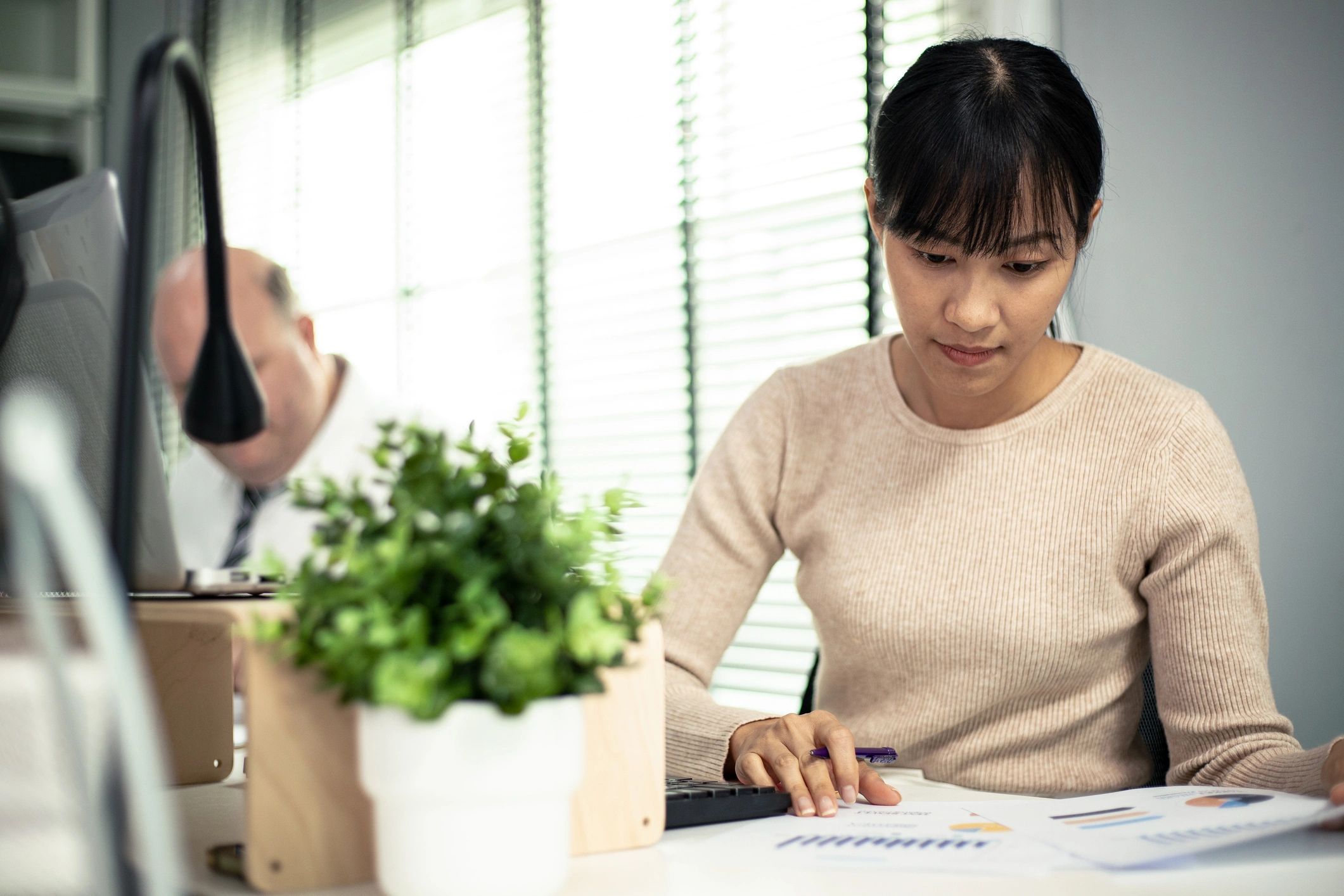 Accountants reviewing financial reports and discussing figures at an office table